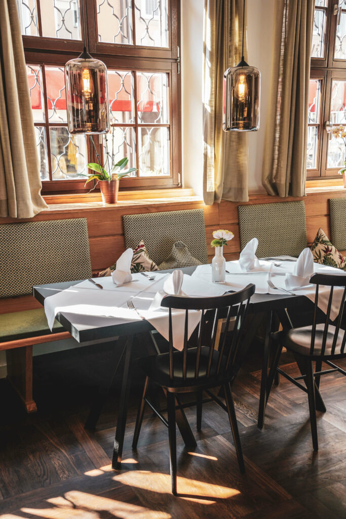 Restaurant mit gedeckten Tischen im Hotel Zur Stadt Mainz in Wuerzburg