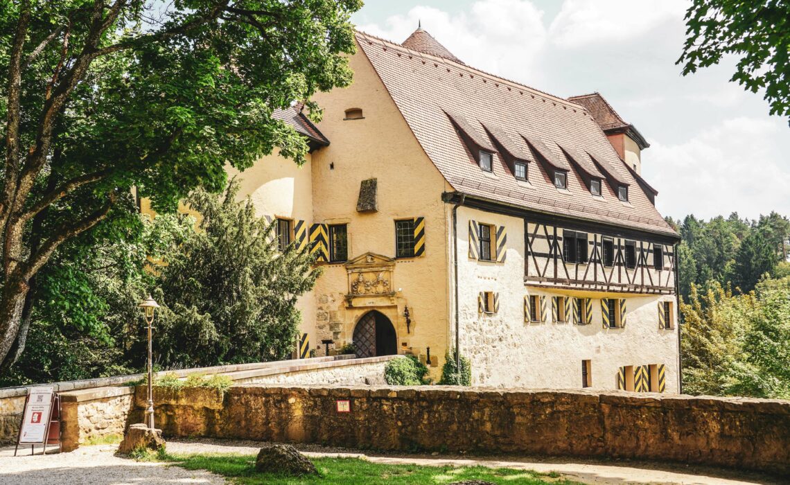 Burg Rabenstein im Sommer mit Fensterläden in Gelb und Schwarz